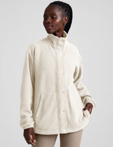 white fleece button up jacket with a full front zip and snap closures and pockets.